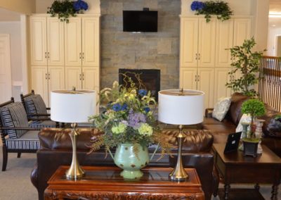 Warm and inviting home lobby featuring leather couches and a fireplace.