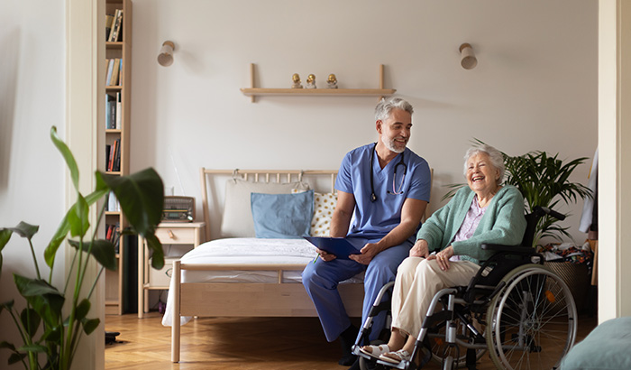 An elderly woman in a wheelchair with a man, showing care and support in their companionship.