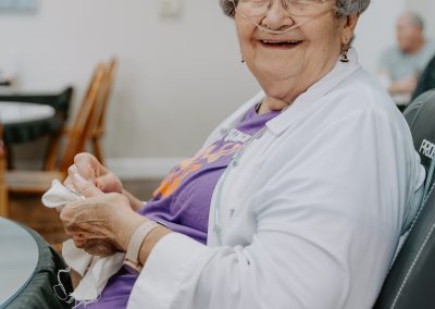 Close-up of a cheerful woman with a big smile on her face.