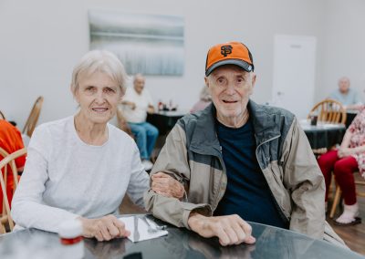 An older couple enjoying a meal at a restaurant, creating cherished memories in a cozy ambiance. Perfect for quality time together.